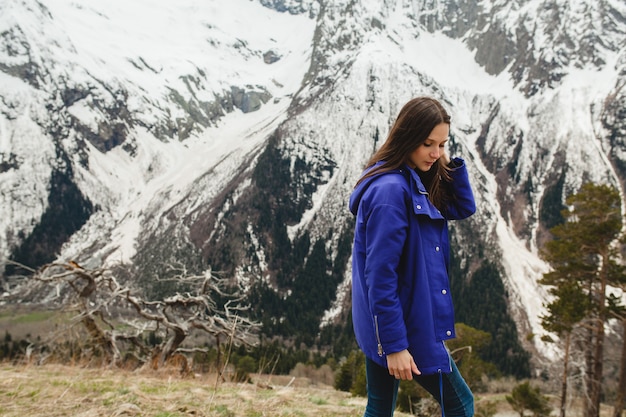 Young hipster woman walking in mountains