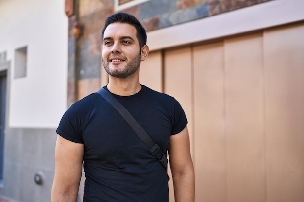 Free photo young hispanic man smiling confident standing at street