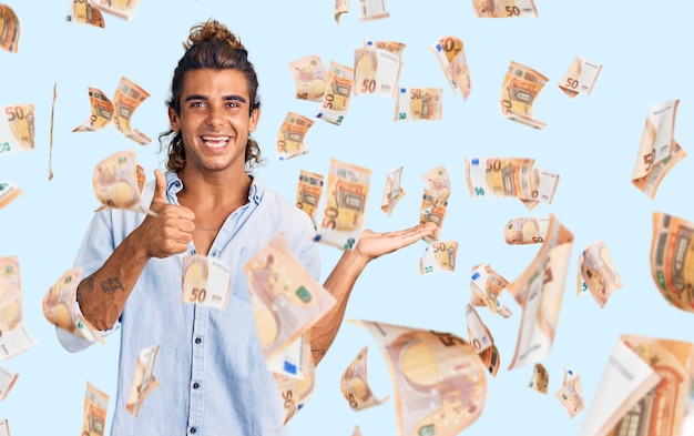 Young hispanic man wearing summer style showing palm hand and doing ok gesture with thumbs up smiling happy and cheerful