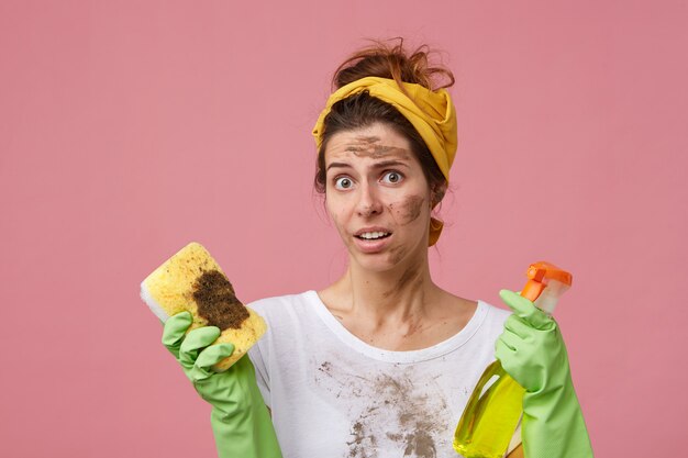 Young housewife looking surprisedly having dissatisfied expression