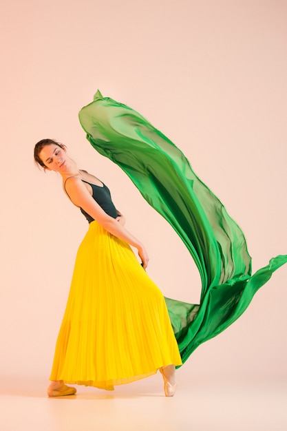 Young and incredibly beautiful ballerina is dancing at studio