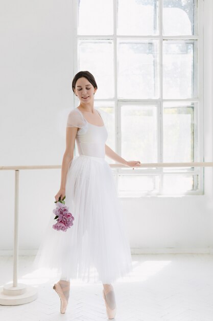 Young and incredibly beautiful ballerina is posing and dancing