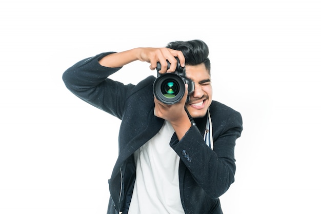 Young indian man with camera isolated over white background