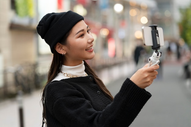 Young japanese influencer recording vlog