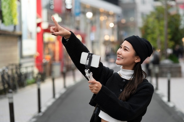 Young japanese influencer recording vlog