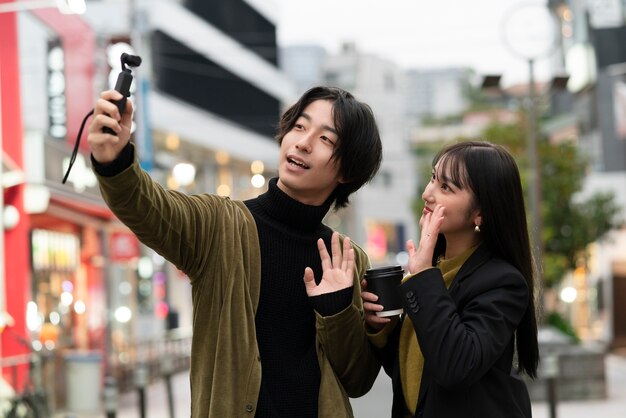 Young japanese influencer recording vlog