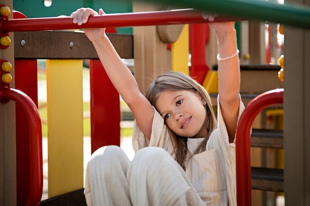 Free photo young kid having fun at the outdoors playground