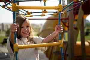 Free photo young kid having fun at the outdoors playground