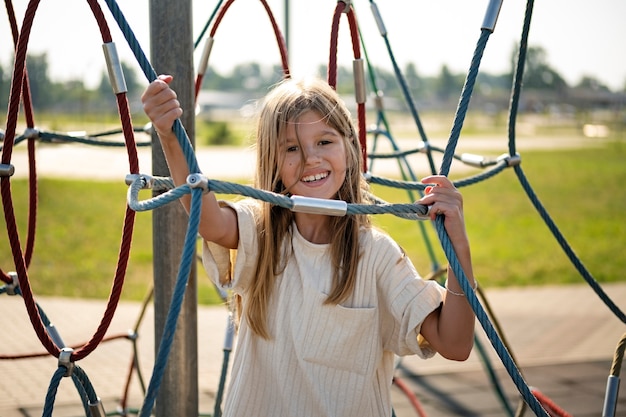 Free photo young kid having fun at the outdoors playground