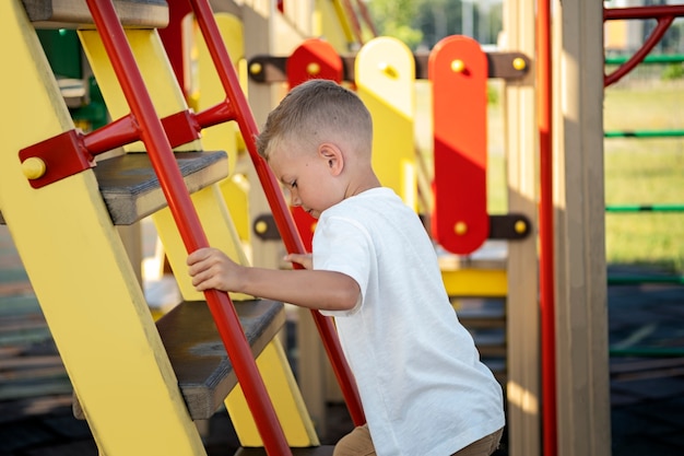 Young kid having fun at the outdoors playground