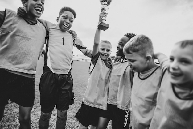 Free photo young kids on the field celebrating their victory