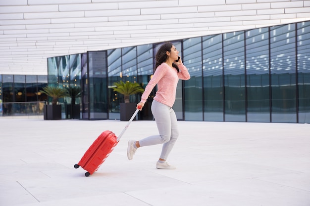 Free photo young lady being late for boarding plane