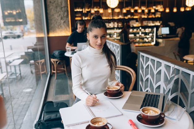 Young lady browsing the internet at the cafe