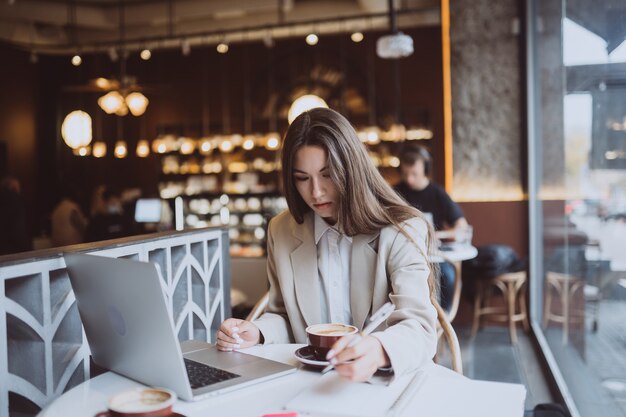 Young lady browsing the internet at the cafe