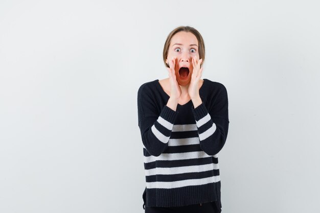 Free Photo young lady in casual shirt shouting or announcing something