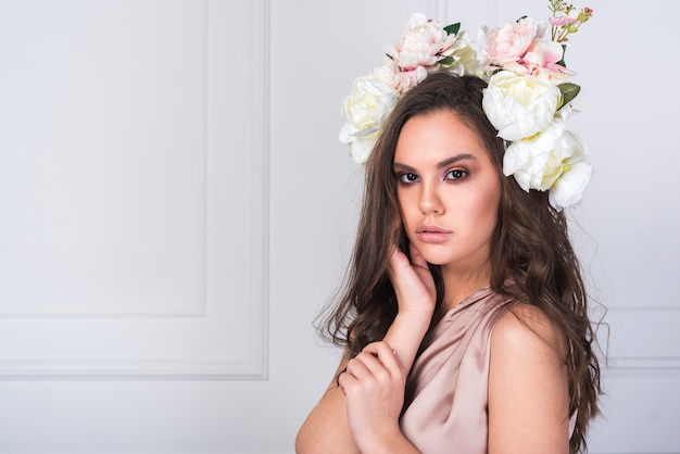 Young lady in dress with fresh flowers on head