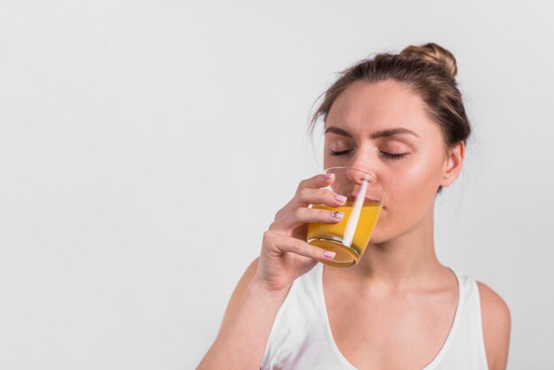 Young lady drinking juice from glass