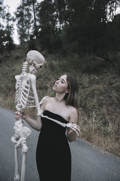 Free photo young lady holding bones