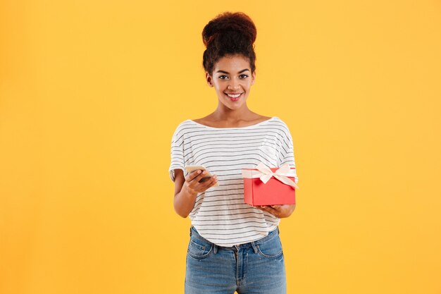 Young lady holding phone and present