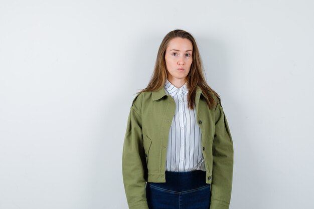 Young lady looking at camera in shirt, jacket and looking sensible. front view.