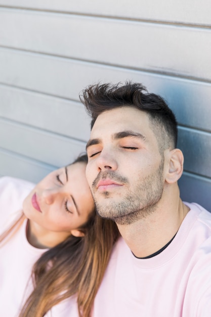 Free photo young lady near handsome guy with closed eyes