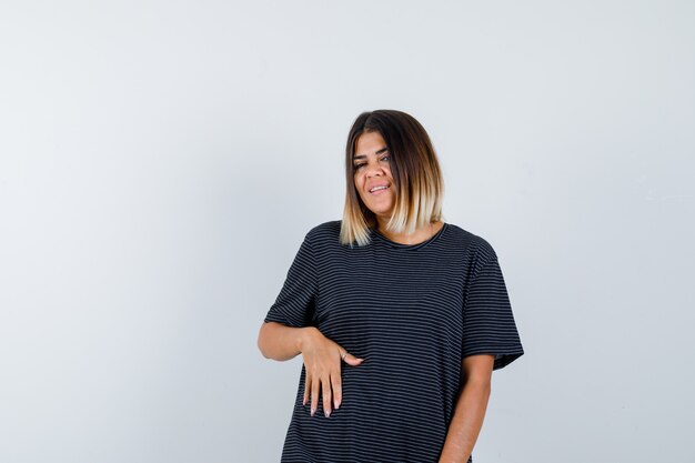 Free Photo young lady posing while standing in polo dress and looking cheerful , front view.