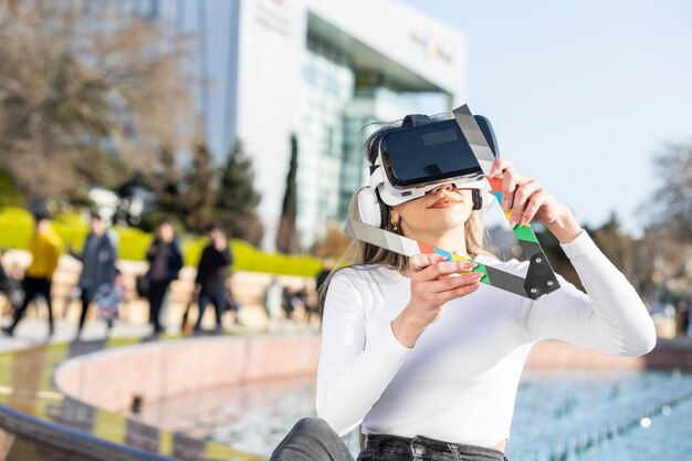 Young lady wears VR set and sitting on the street