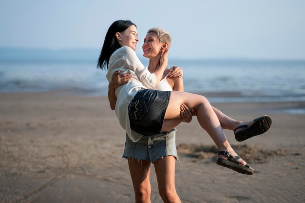 Young lesbian couple carrying