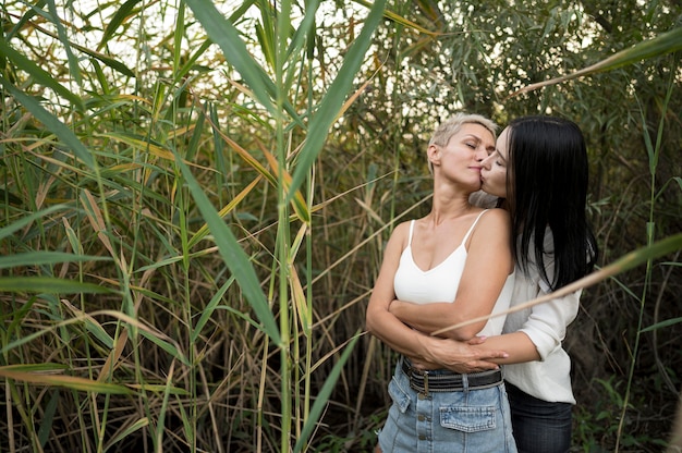 Young lesbian couple hug and kiss