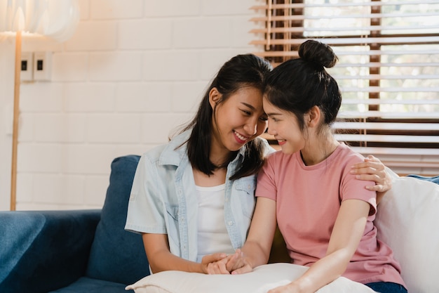 Young Lesbian lgbtq Asian women couple hug and kiss at home