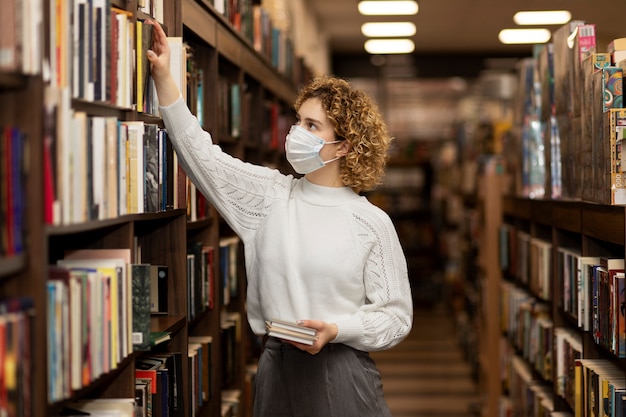 Young librarian organising books