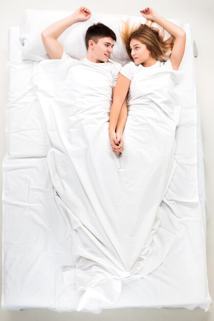 The young lovely couple lying in a bed