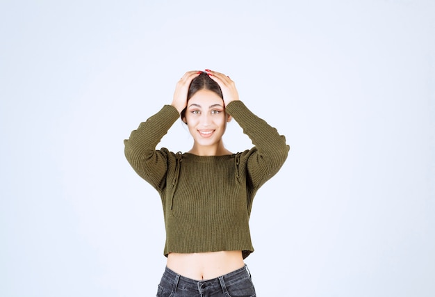 Free photo a young lovely woman model covering her head with her hands