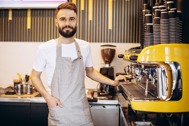 Free photo young male barista working at a coffee house