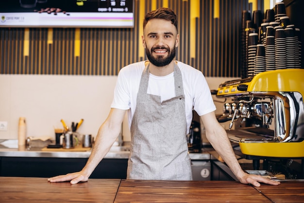 Free photo young male barista working at a coffee house