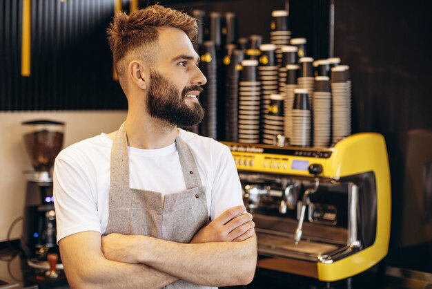 Young male barista working at a coffee house