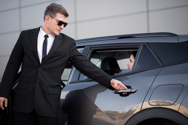 Young male being an uber driver for a female client