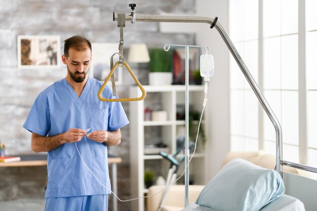 Young male doctor in modern nursing home. Modern facility.