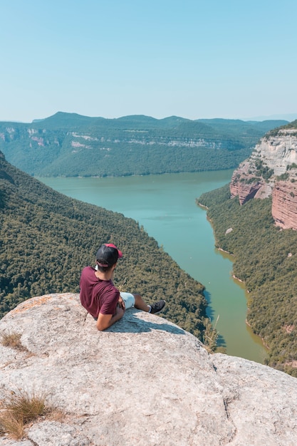 Young male enjoying the mesmerizing scenery of the Morro de la Abeja in Tavertet, Catalonia, Spain