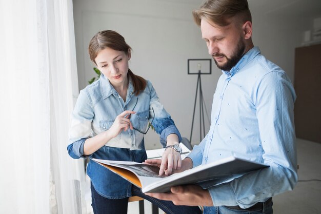 Young male and female architect working at office