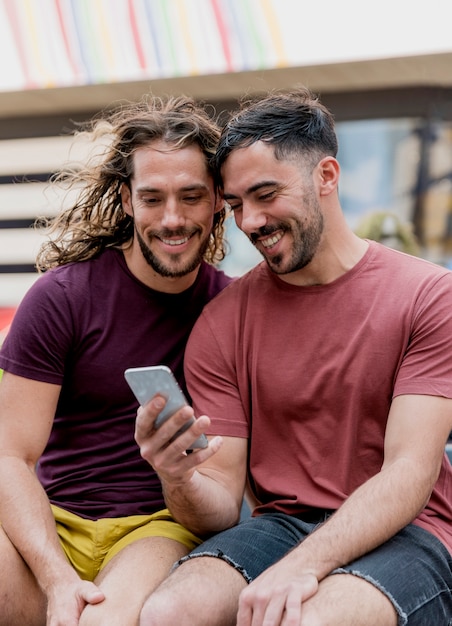 Young male friends looking at mobile