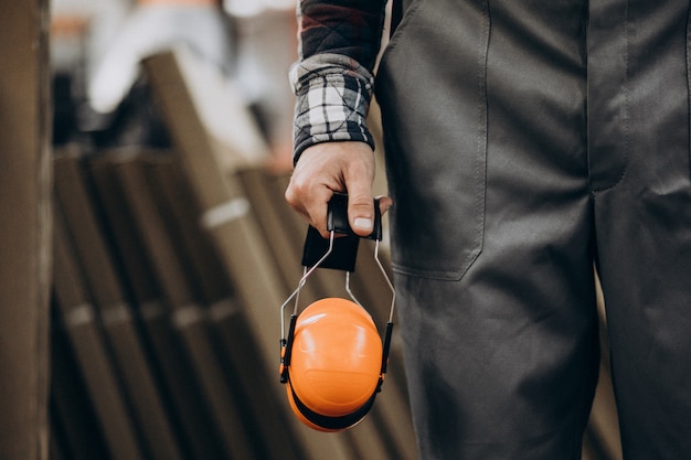 Free photo young male handyman with safety earphones