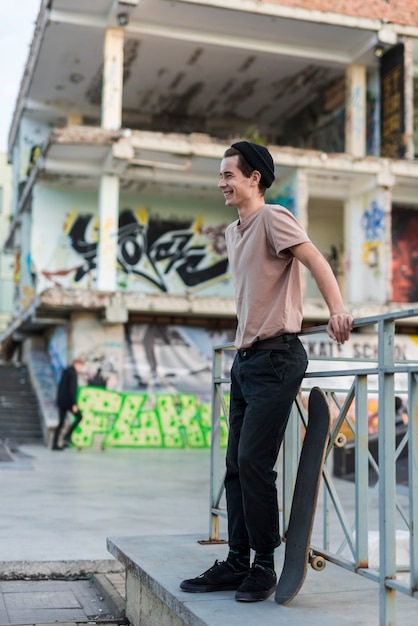 Young male model posing with skateboard