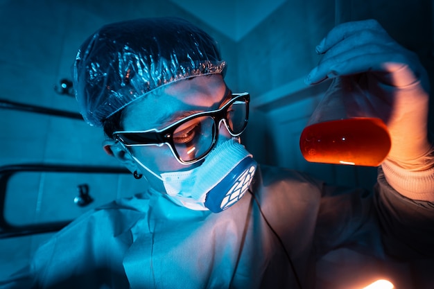 Young male researcher carrying out scientific experiment.