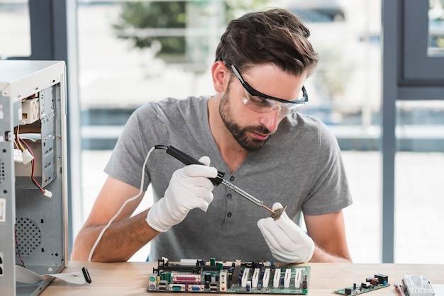 Free Photo young male technician working on computer ram