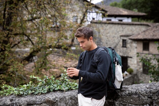 Young male traveler checking his smartphone