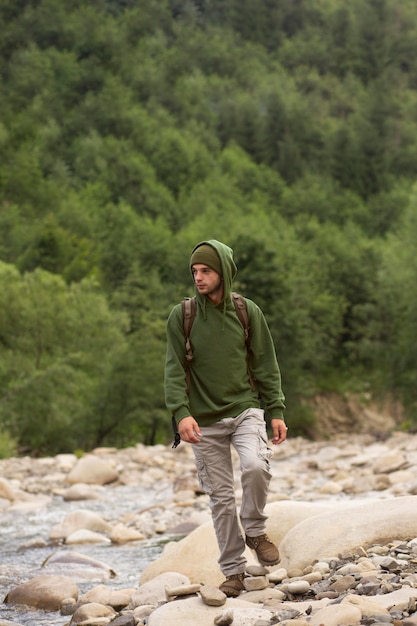 Young male traveler enjoying rural surroundings