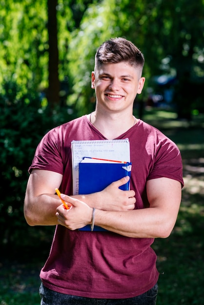 Young male with study materials in park