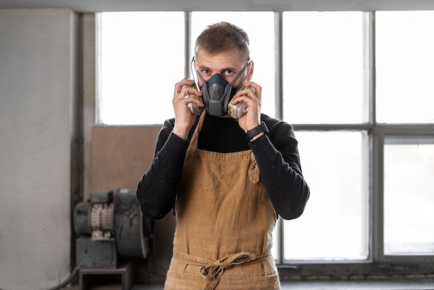 Free photo young male working in a wood engraving workshop