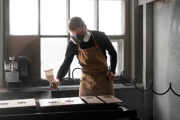 Free photo young male working in a wood engraving workshop